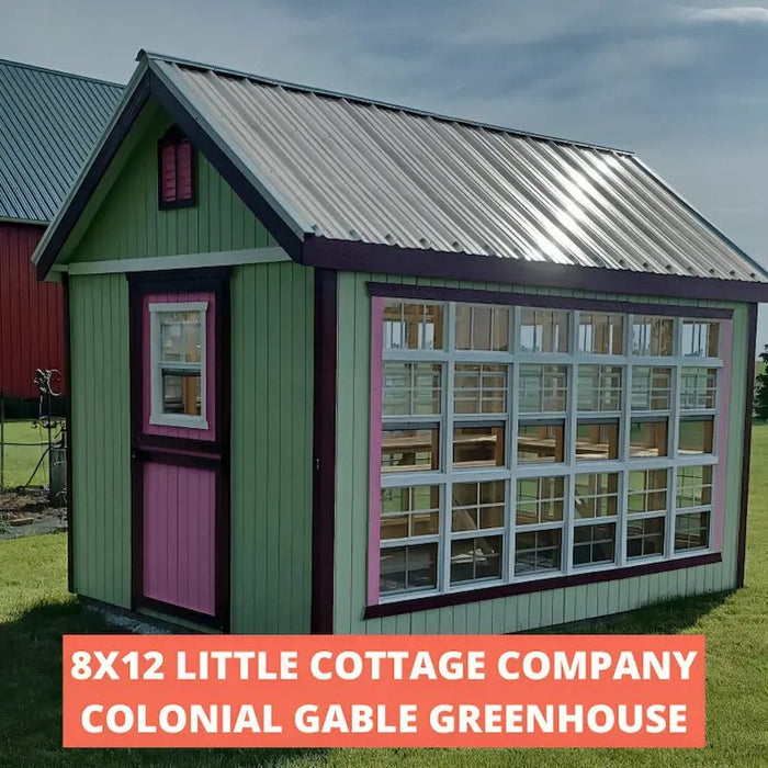 little cottage company colonial gable greenhouse painted green with pink door