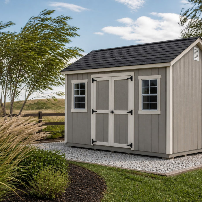 Sturdy backyard shed on a gravel base in a windy yard