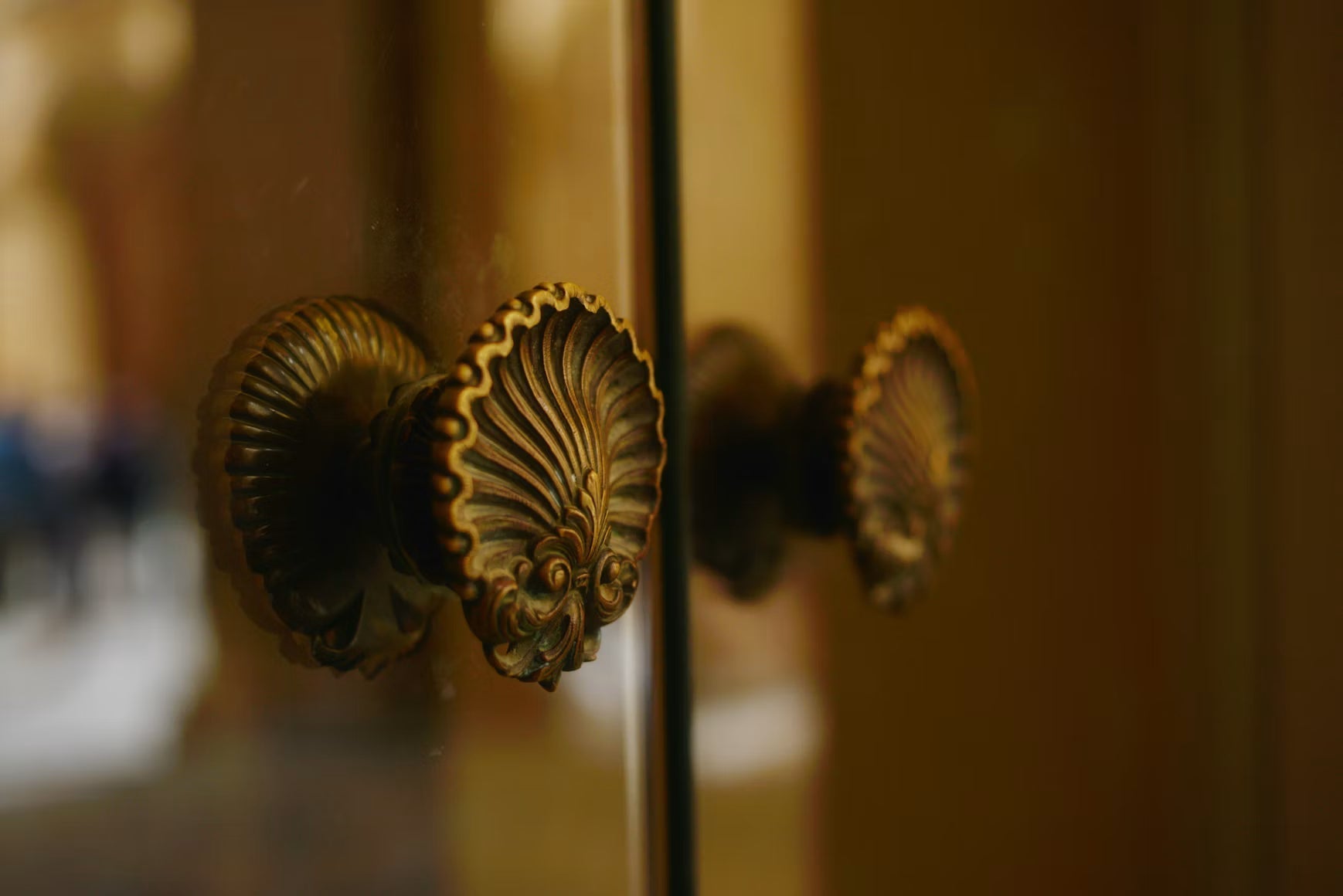 Ornate antique brass doorknob on a wooden door