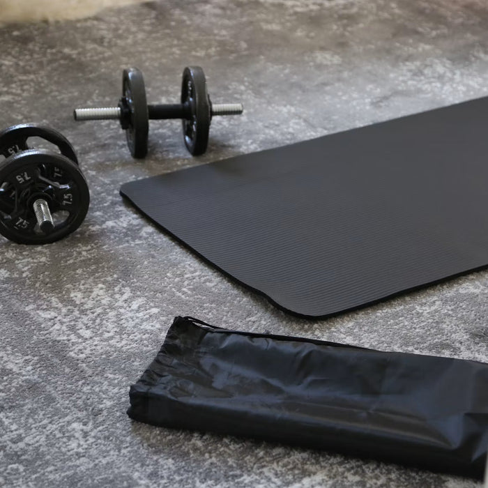 Exercise mat and dumbbells arranged inside a backyard home gym