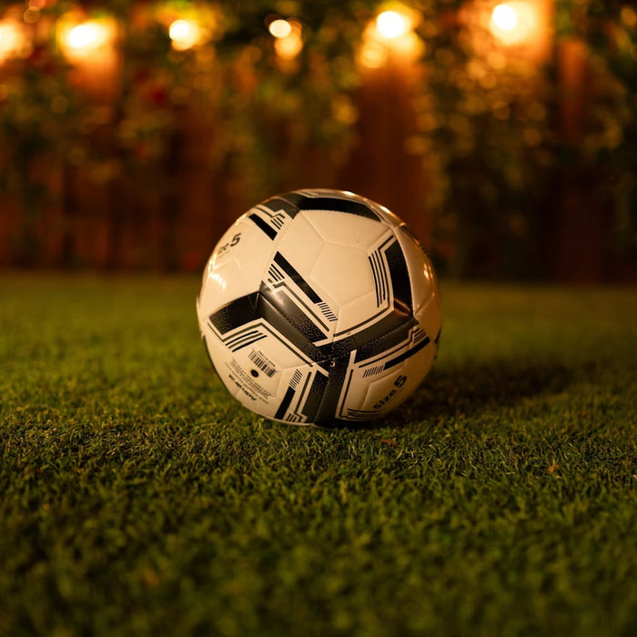 Soccer ball on a backyard lawn prepared for outdoor training
