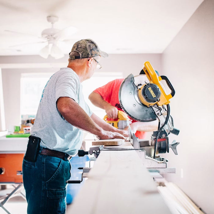 Carpenter cutting wood with a miter saw during a home repair