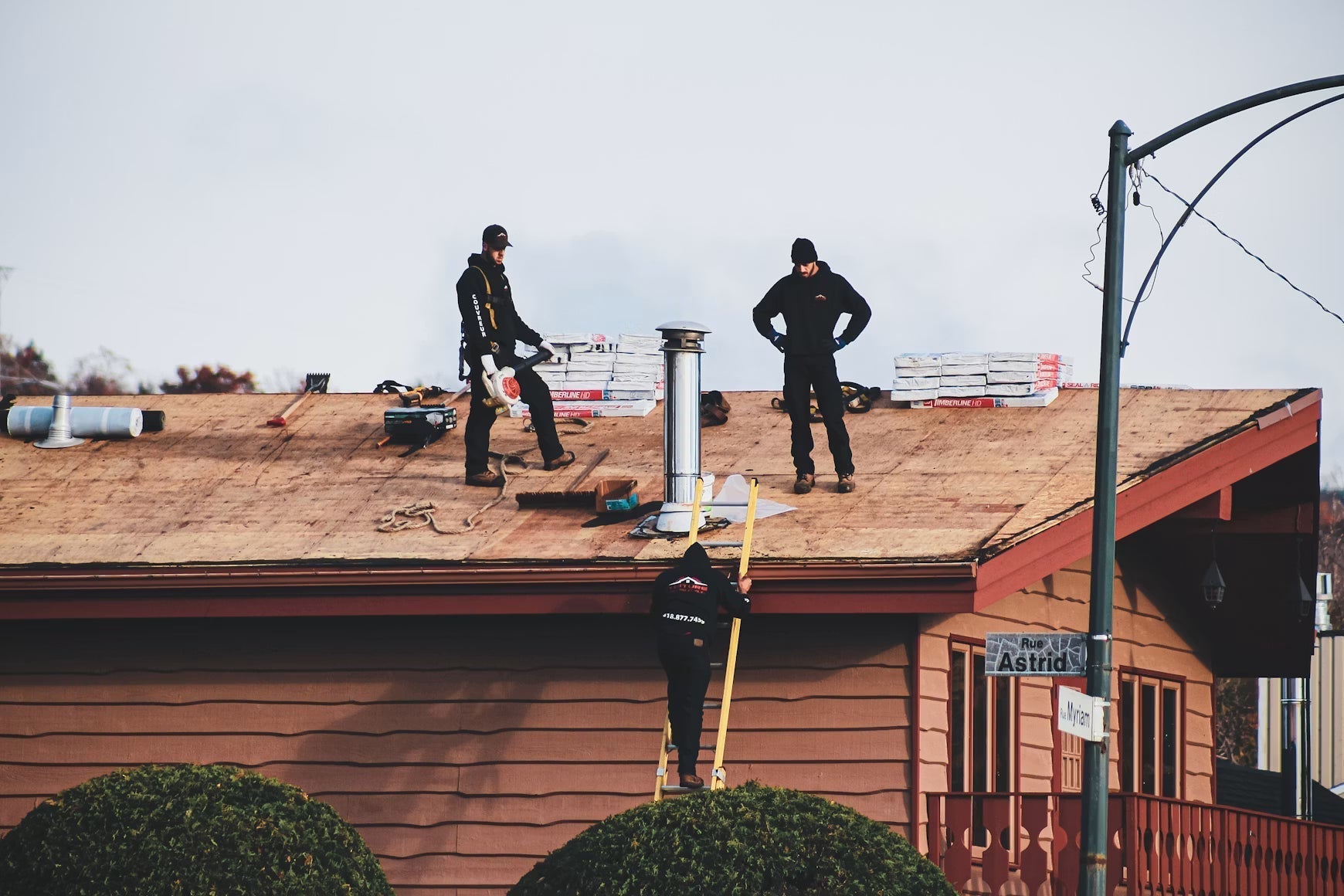 Commercial roofing crew working on a flat roof