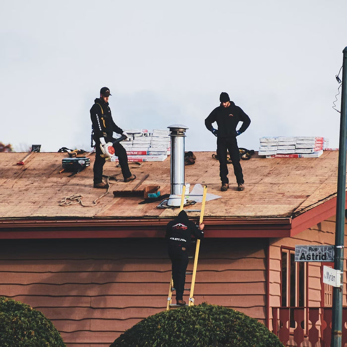 Commercial roofing crew working on a flat roof