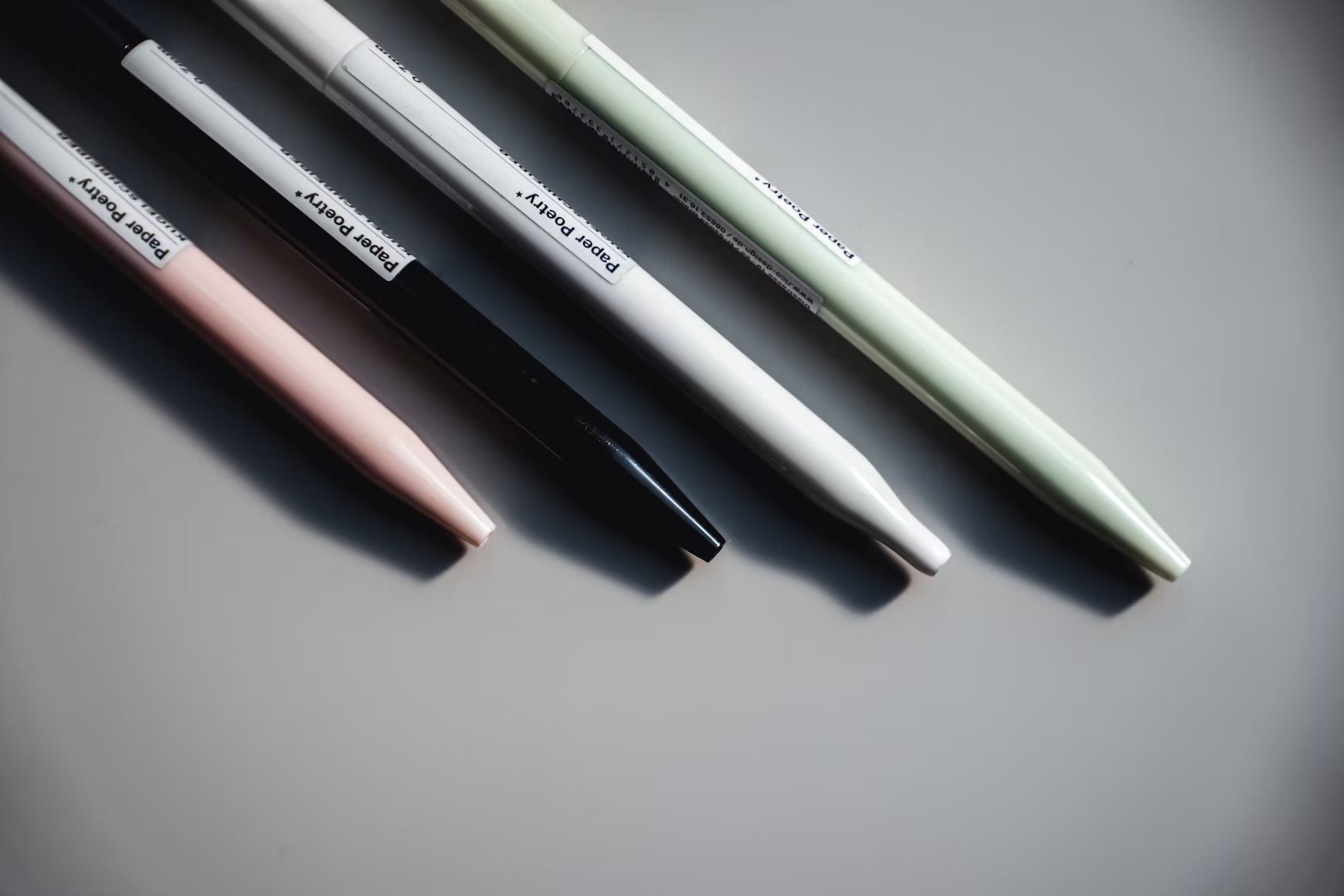 Several mechanical pencils arranged on a gray surface