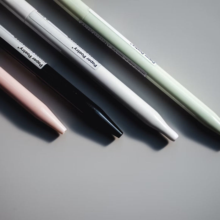 Several mechanical pencils arranged on a gray surface