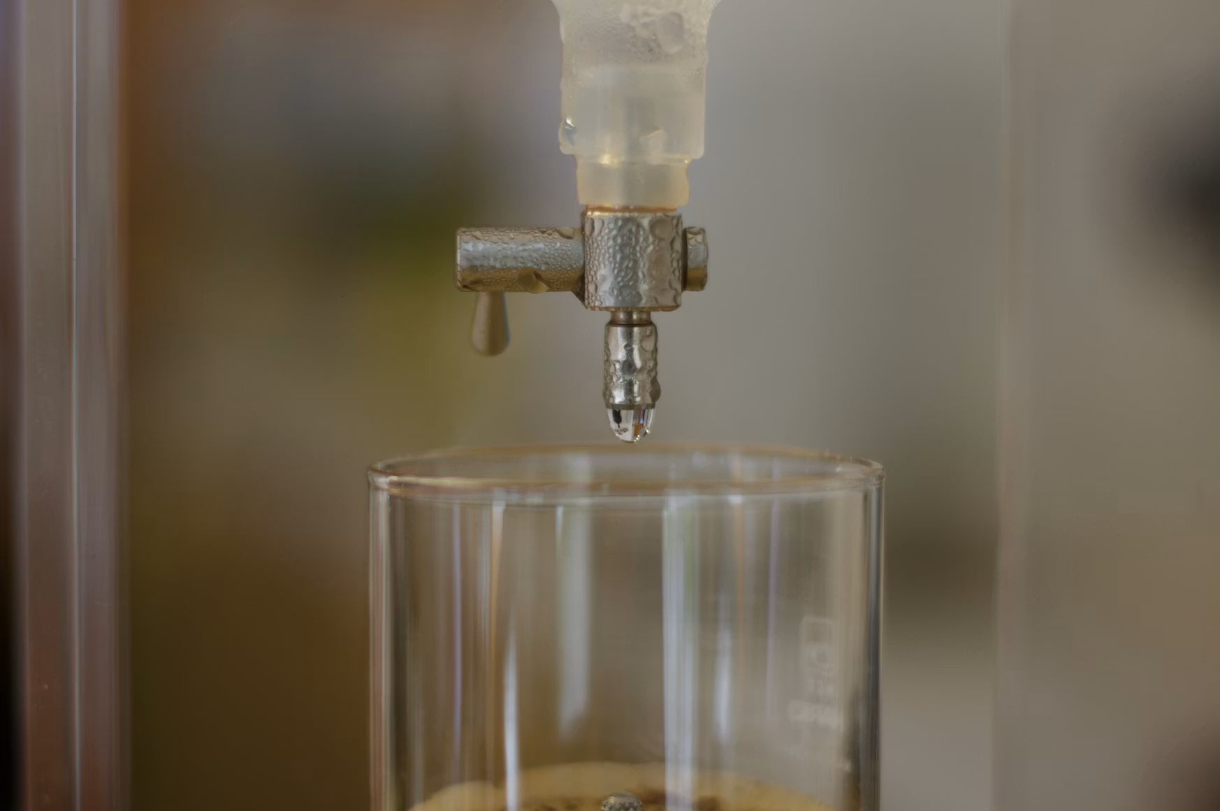 Countertop gravity water filter dispensing water into a glass