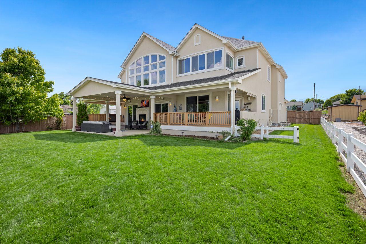 Detached home with a large lawn and a covered porch