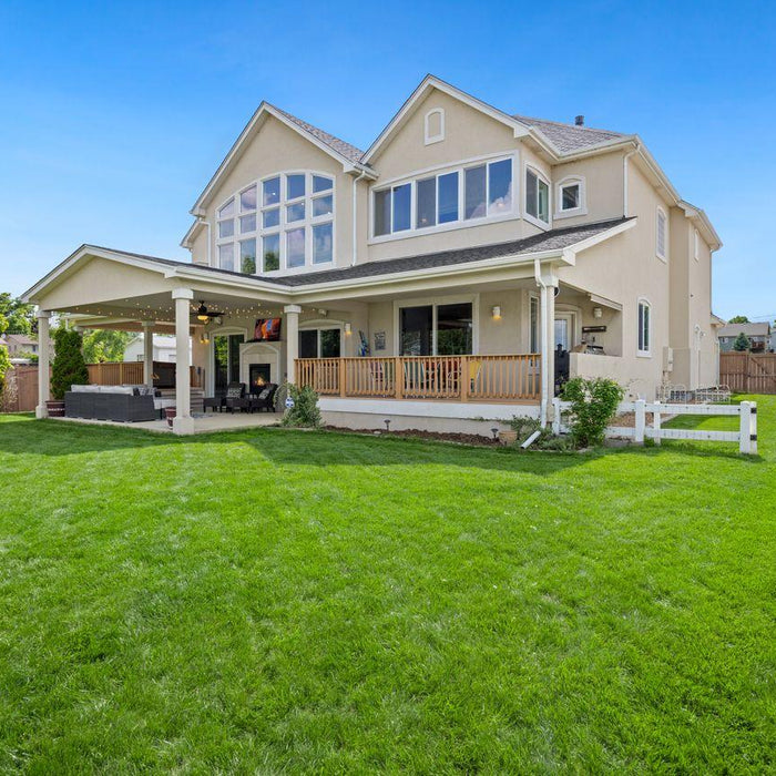 Detached home with a large lawn and a covered porch