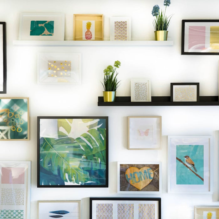 Gallery wall with framed artwork and floating shelves