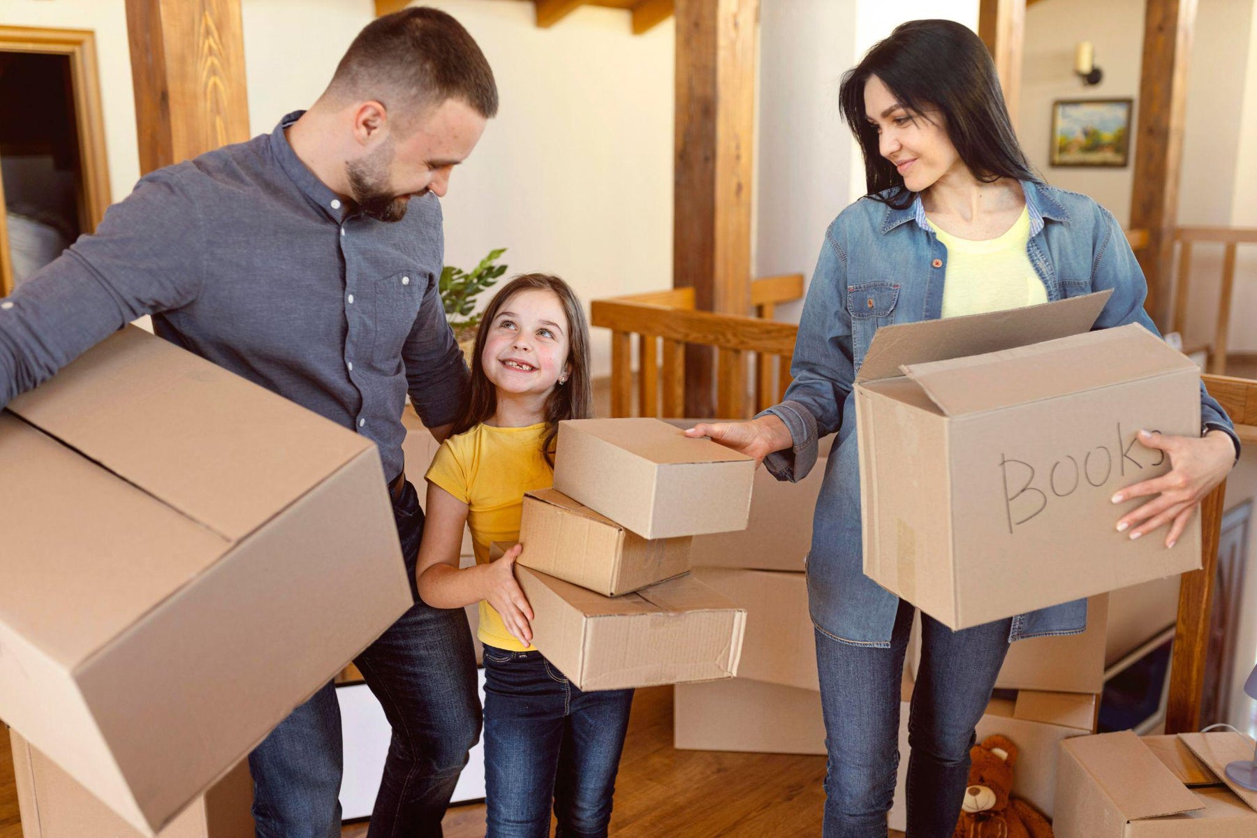 Family packing boxes for a residential move