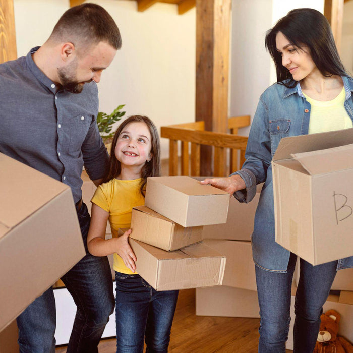 Family packing boxes for a residential move