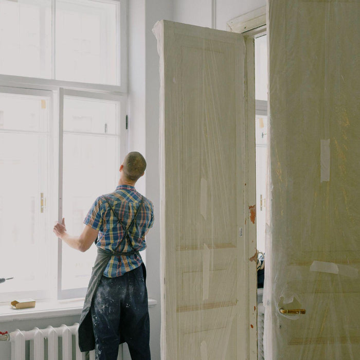 Handyman installing a window during a major home repair