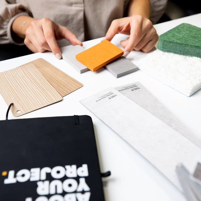 Remodeling material samples and plans spread across a worktable