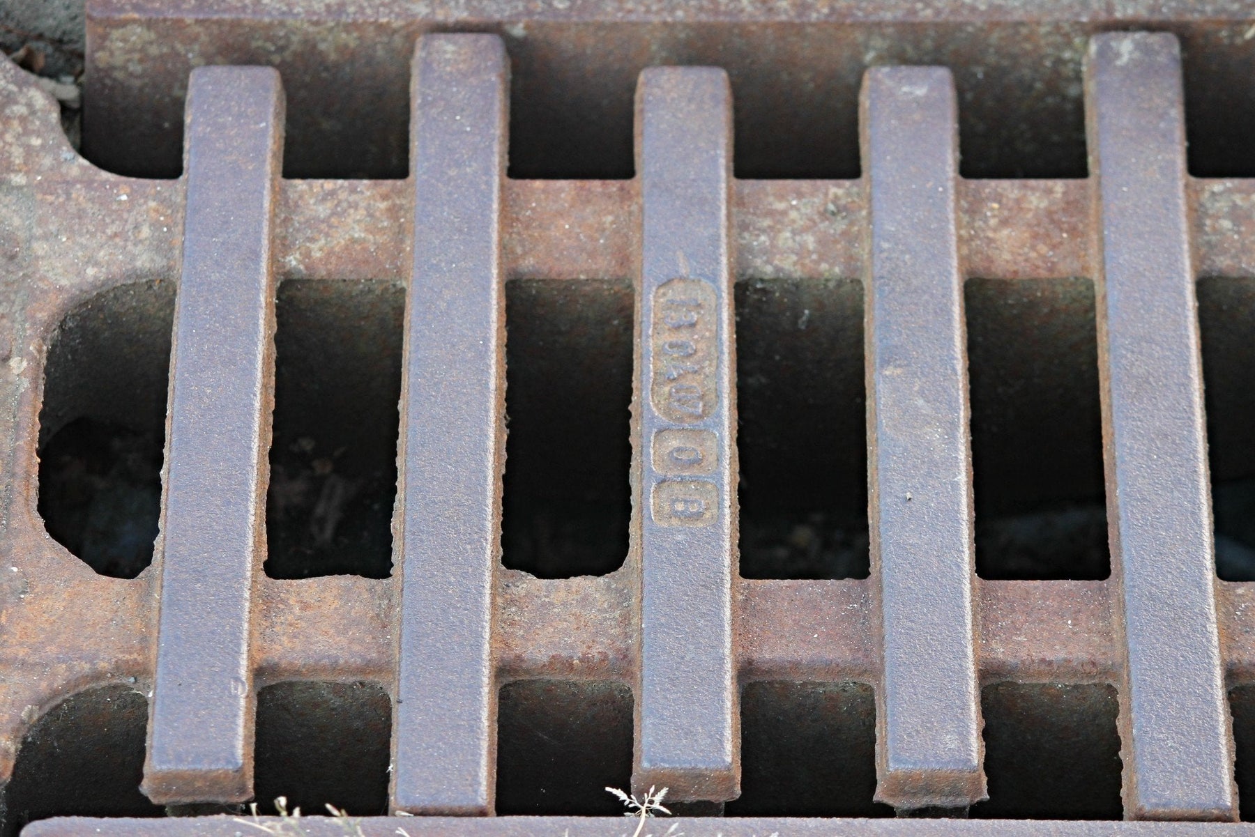 Concrete trench drainage channel beside a road construction area