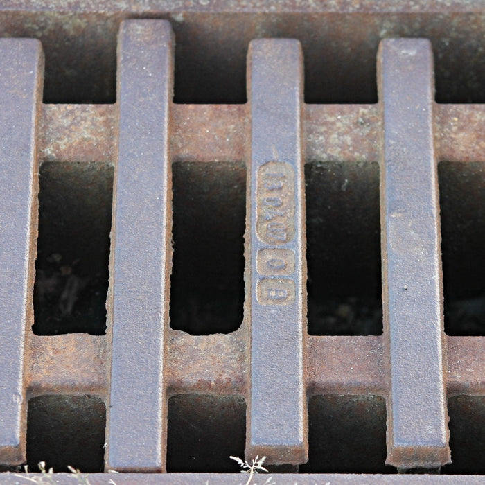 Concrete trench drainage channel beside a road construction area