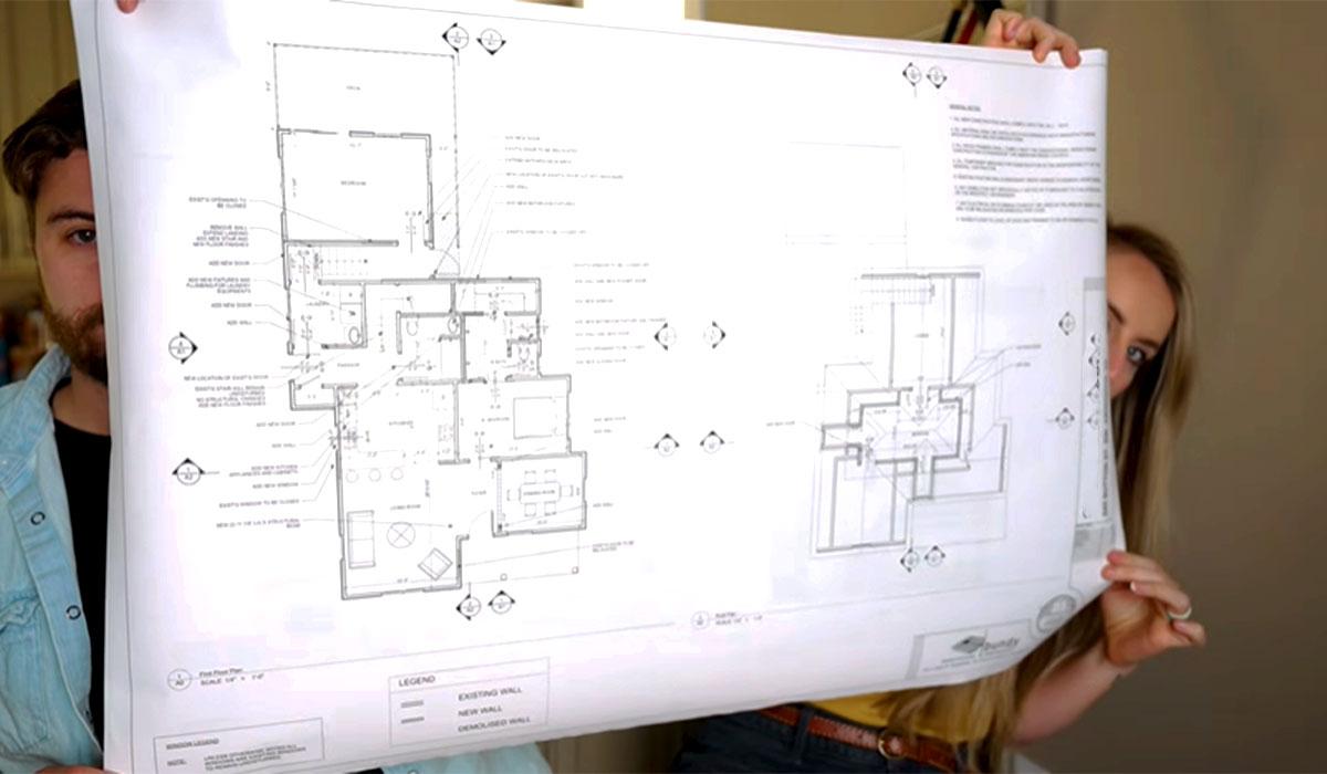 Homeowners reviewing architectural plans for a remodeling project