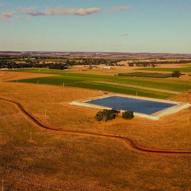 Aerial view of rural acreage with fields and a farm dam