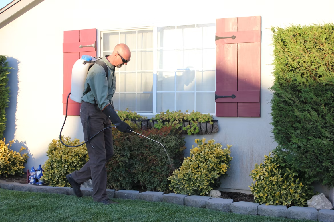 Pest-control worker outside a home