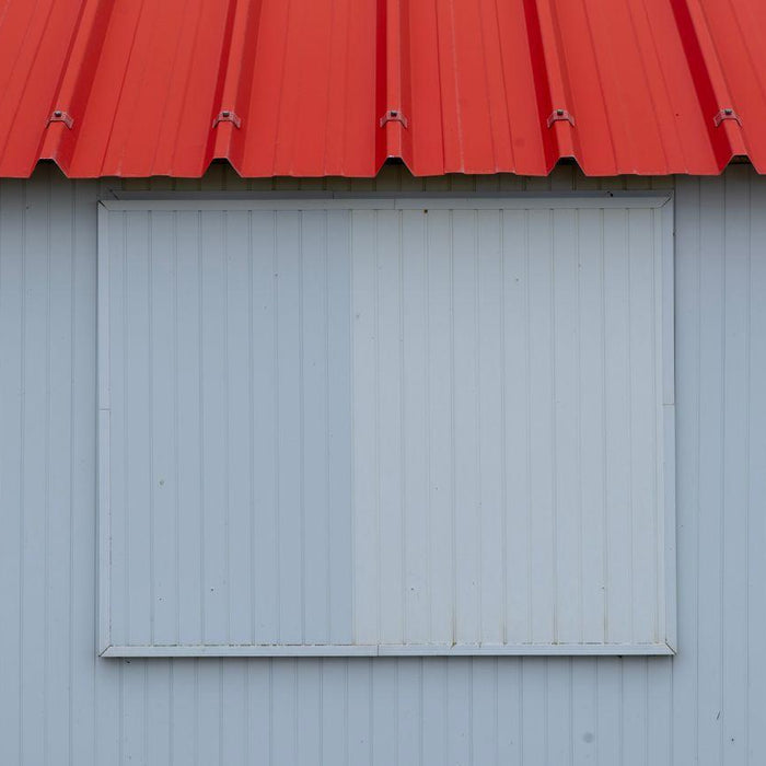 Corrugated red metal roof on a simple shed wall