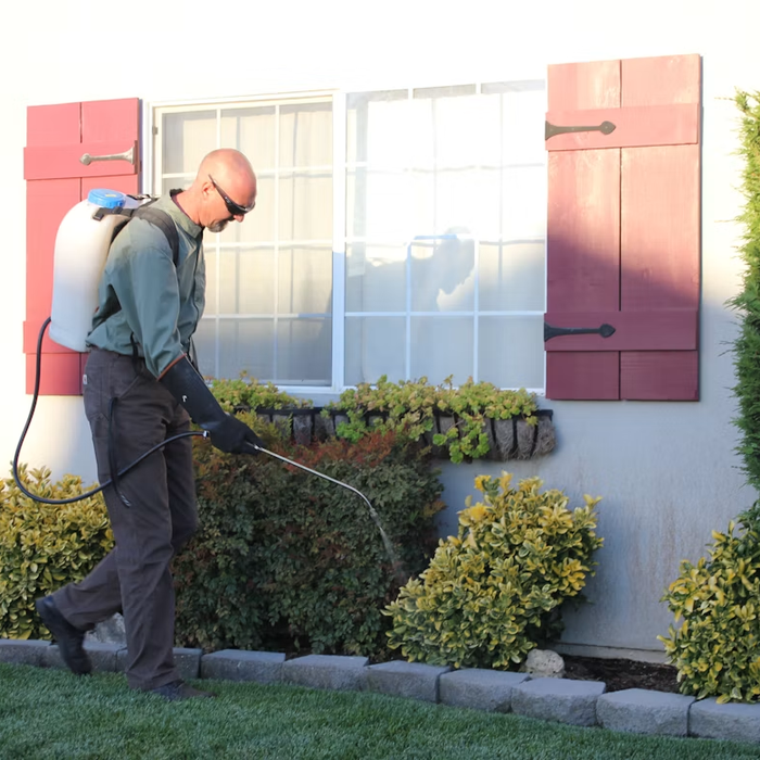 Pest-control worker outside a home