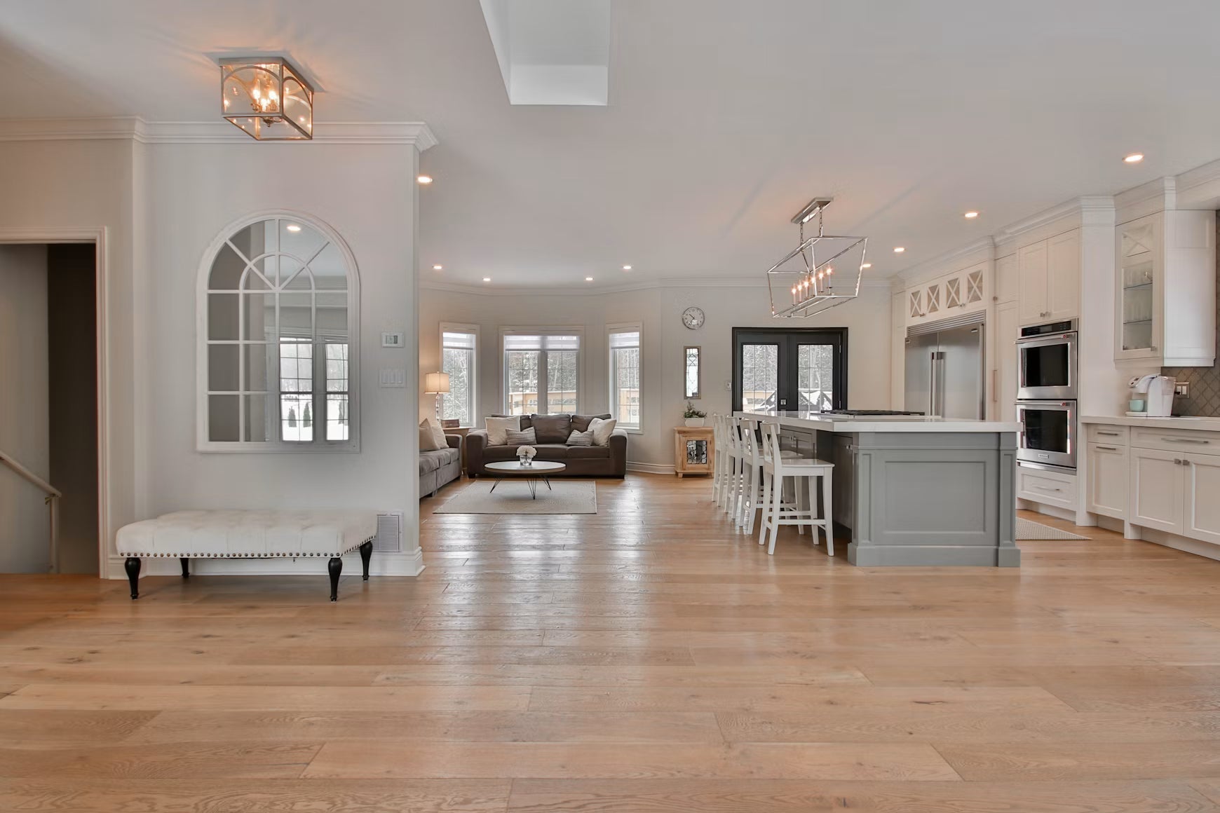 Bright kitchen and living area with wood-look flooring