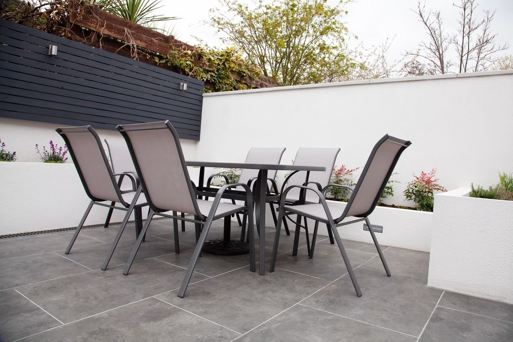 Outdoor dining table and chairs on a tiled patio