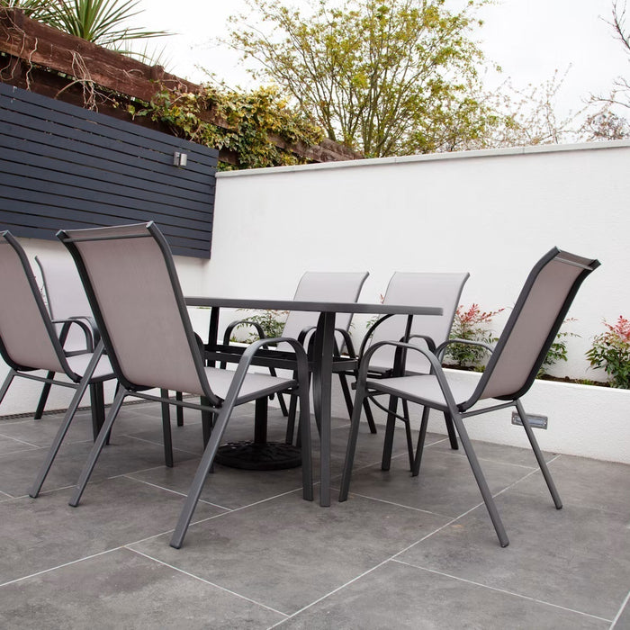 Outdoor dining table and chairs on a tiled patio