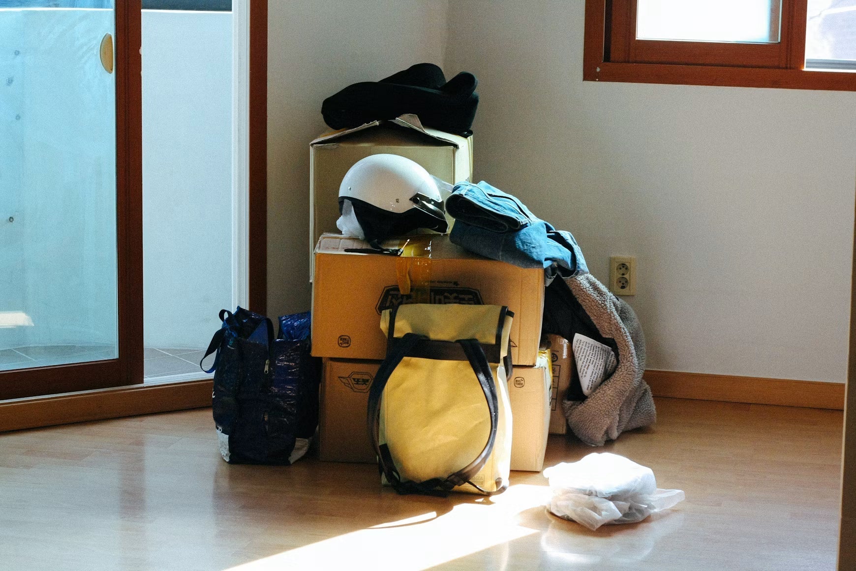 Packed boxes and bags arranged in an empty room