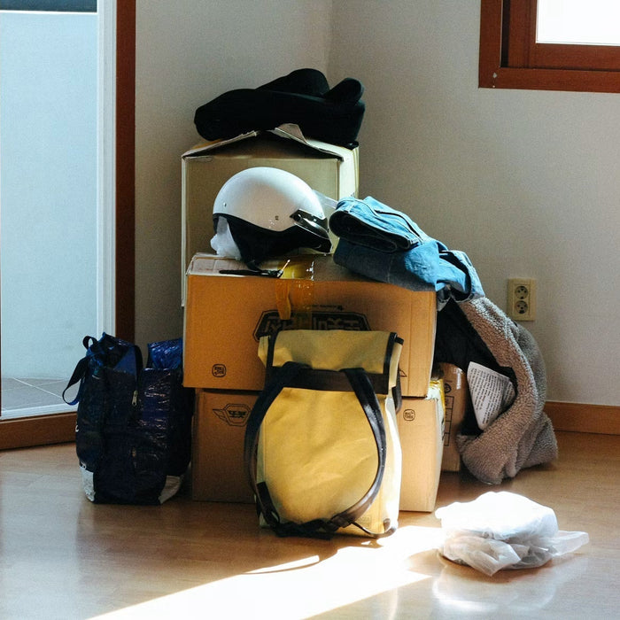 Packed boxes and bags arranged in an empty room