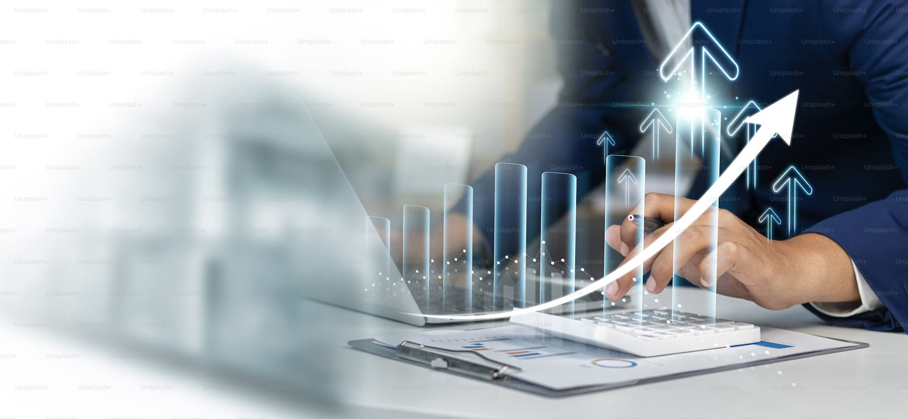 Hand using a laptop beside an upward financial chart graphic