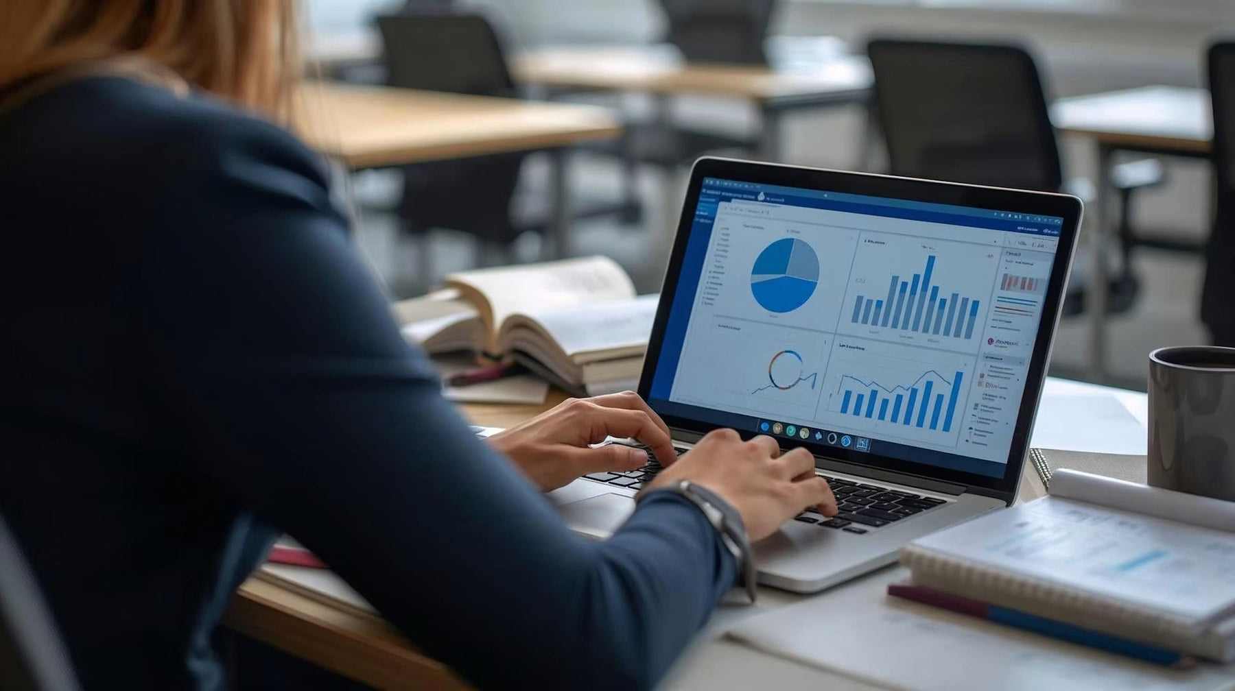 Person reviewing financial charts on a laptop at a desk