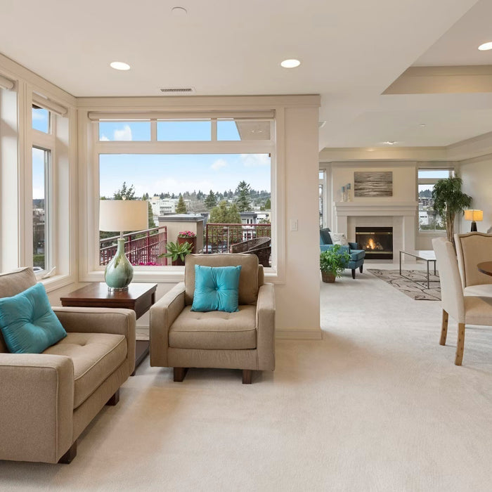 Bright renovated open-plan living room with large windows