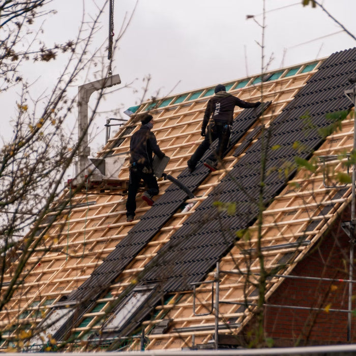 Roofers replacing shingles on a residential roof