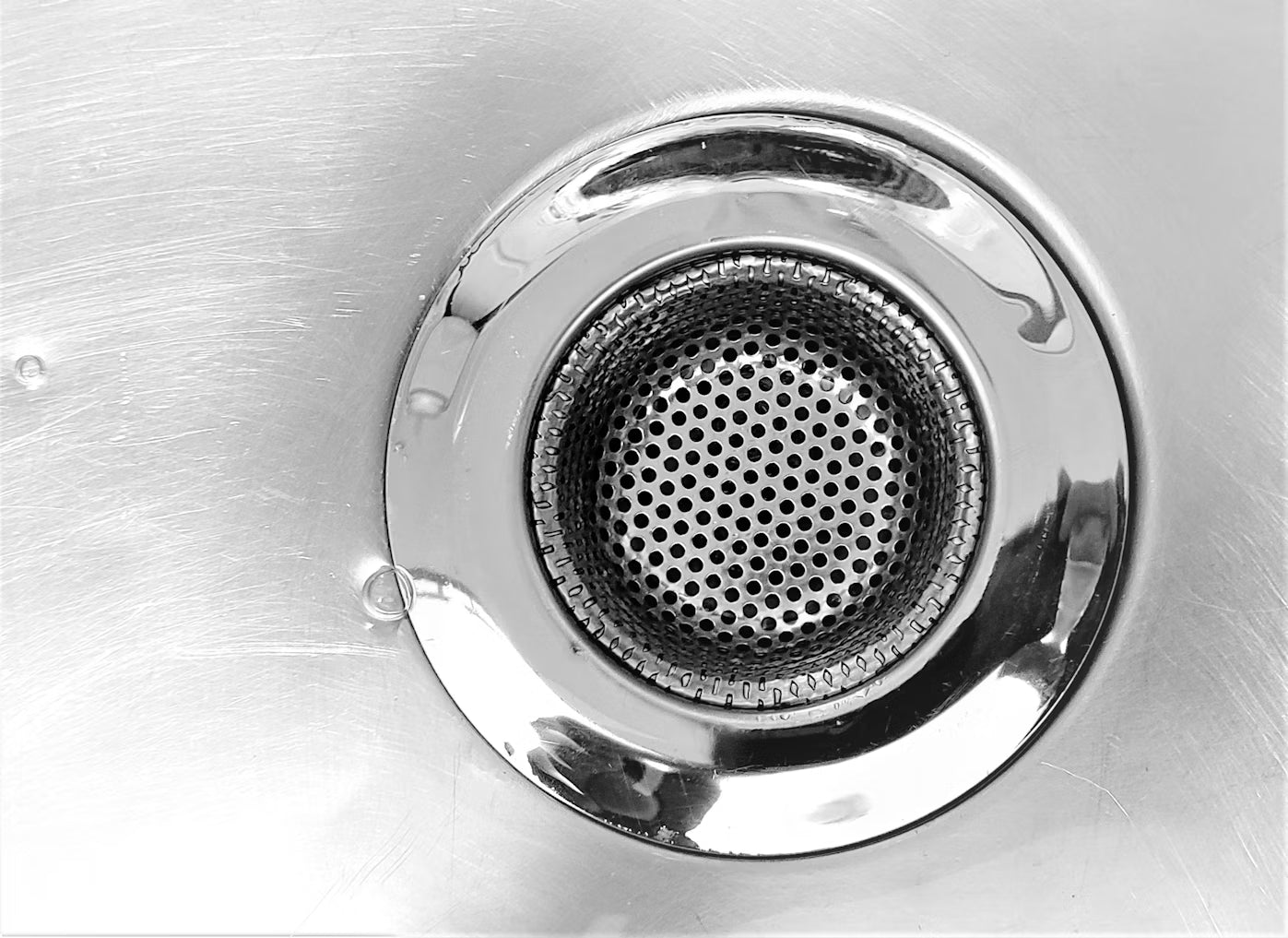 Round stainless steel drain in a metal sink