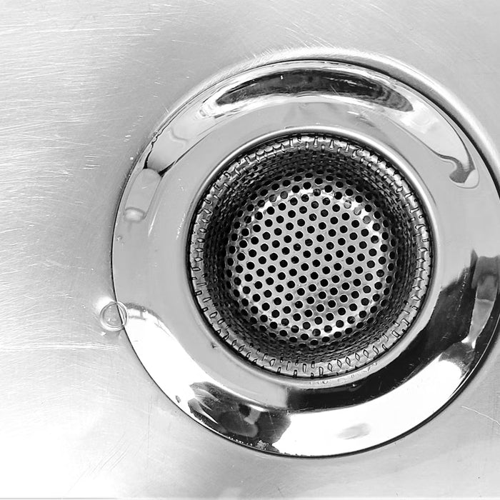 Round stainless steel drain in a metal sink