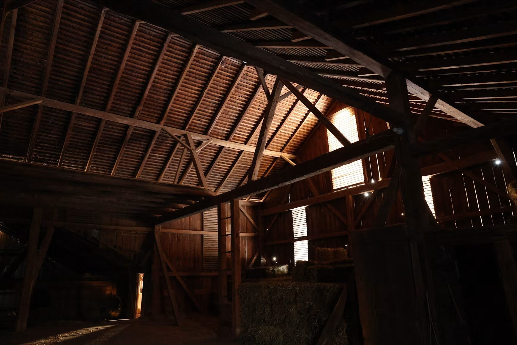 Sunlight entering the timber interior of an empty barn