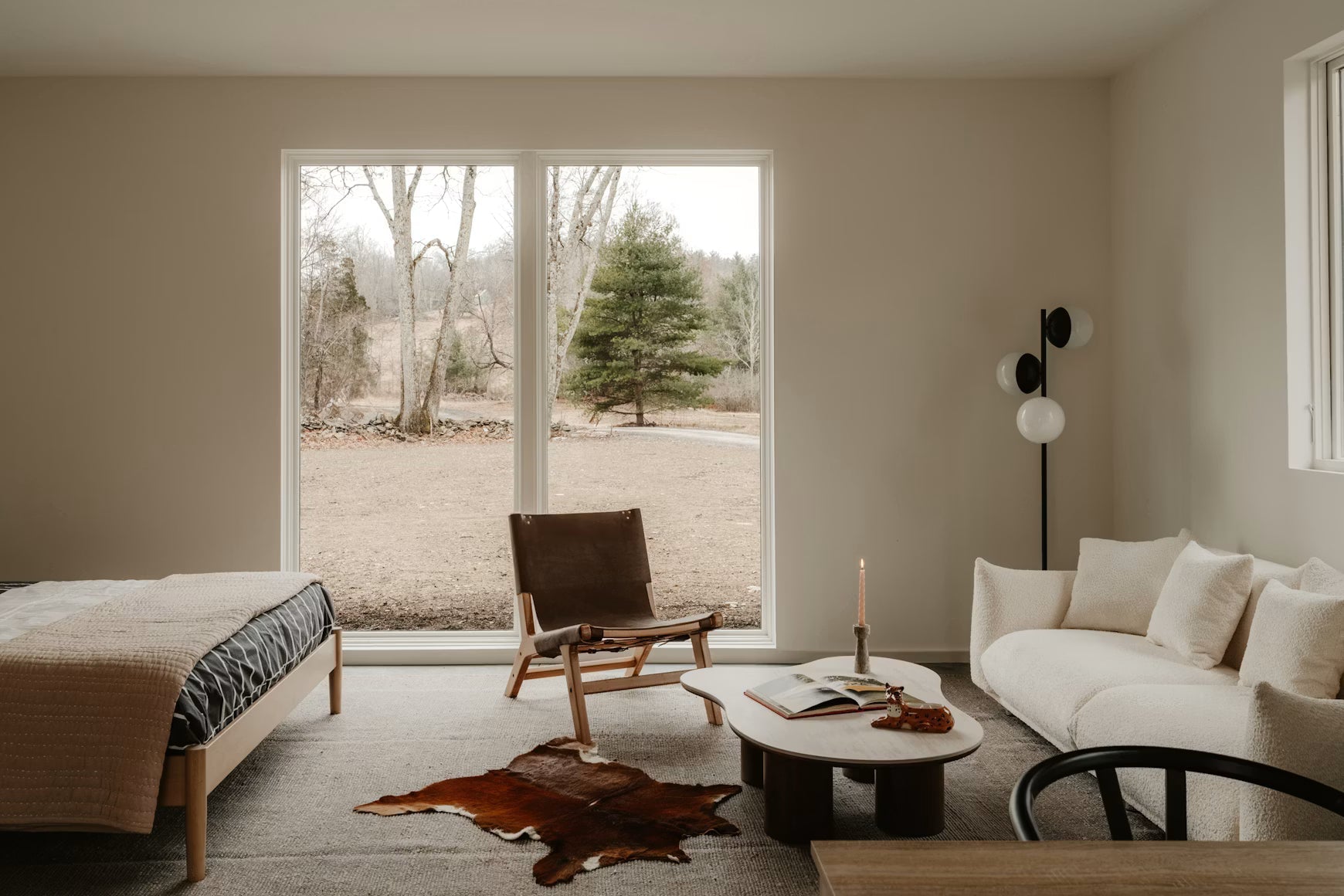 Traditional home living space with neutral furnishings and a large window