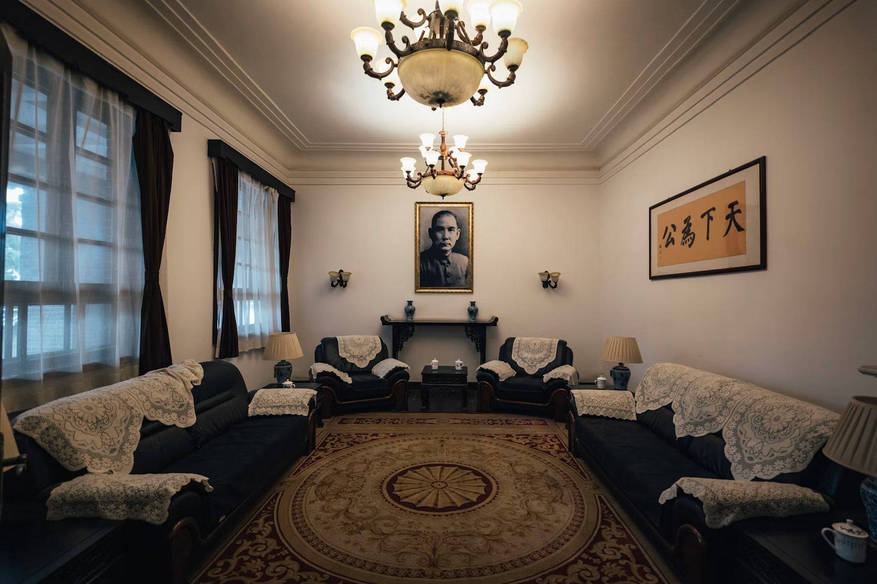 Traditional living room with upholstered sofas, chandelier, and round rug