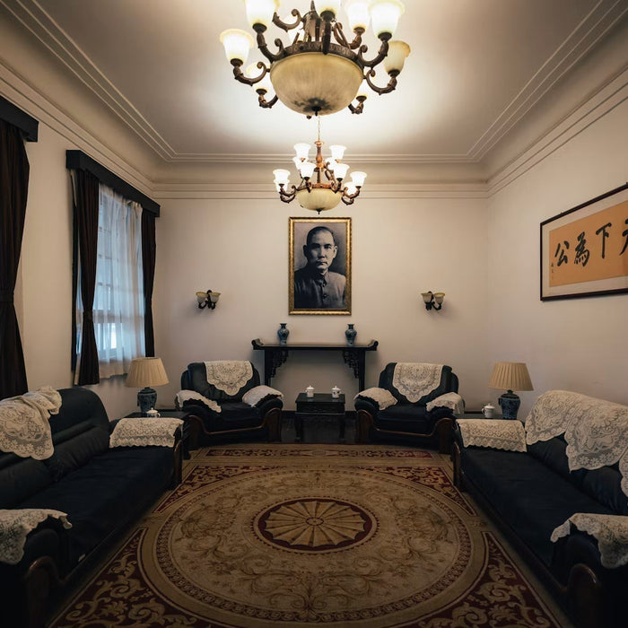 Traditional living room with upholstered sofas, chandelier, and round rug