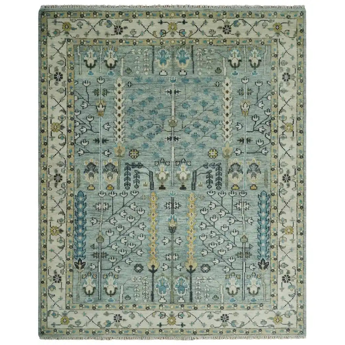 Aqua and ivory traditional Oushak rug flat lay with floral motifs and fringe