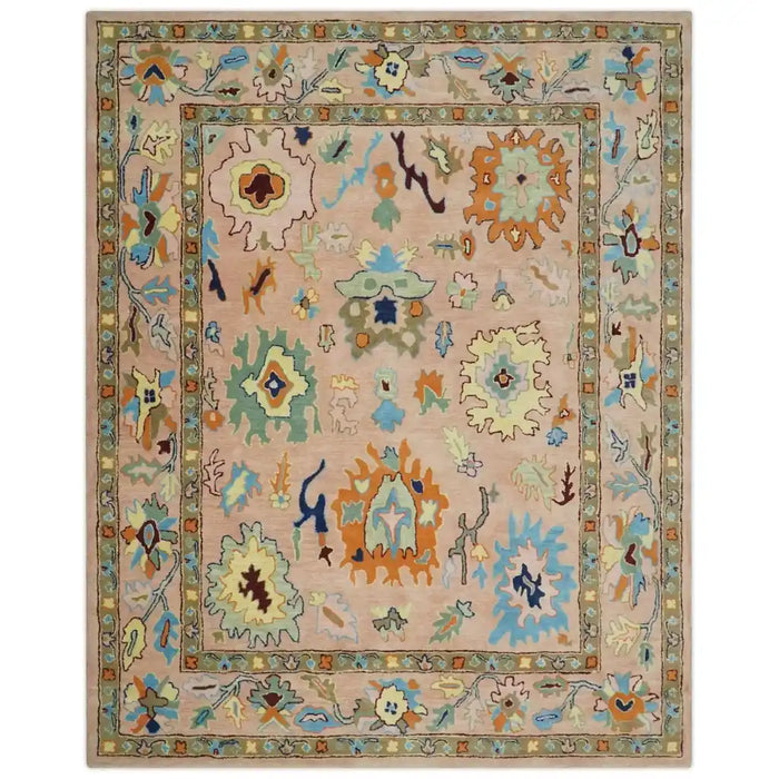 Straight-on view of the peach Oushak rug with its full patterned border