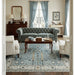 Aqua and ivory Oushak rug beneath living room seating and coffee table