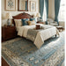Aqua and ivory floral Oushak rug beneath a bed