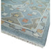 Blue corner pattern and white fringe on beige, blue and ivory hand knotted wool rug