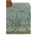Angled view of aqua and ivory rug beside an upholstered ottoman