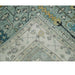 Reverse corner of the rug showing woven backing, bound edge, and fringe