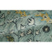 Folded aqua Oushak rug close-up showing texture and floral pattern