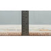 Side view of the rug pile beside a metal ruler