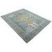 Full beige, blue and ivory hand knotted wool area rug shown at an elevated oblique angle